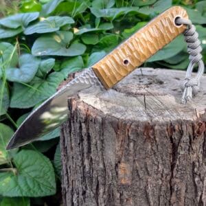 “Angled artistic photo of the Mowgli knife showing blade geometry and ergonomic handle.”