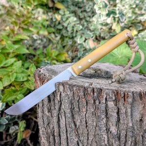 Close-up of Mr Wick knife blade showing flat grind, sharp cutting edge, and polished finish handmade in Ukraine.