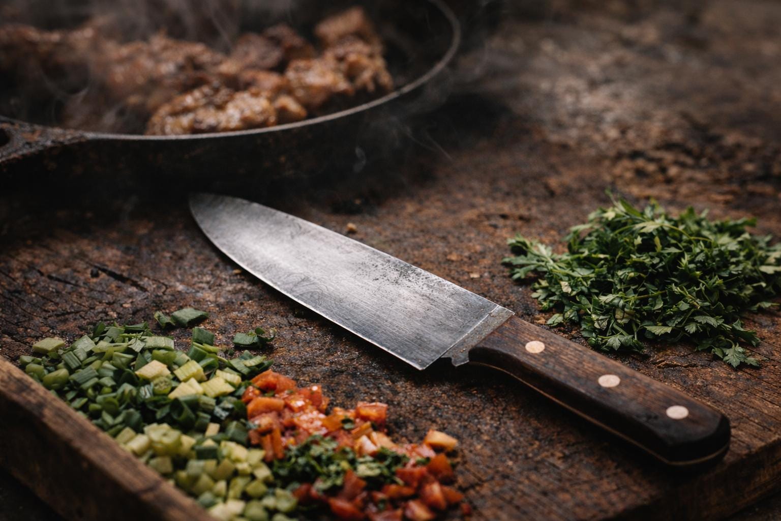 An unused chef knife resting on a clean cutting board